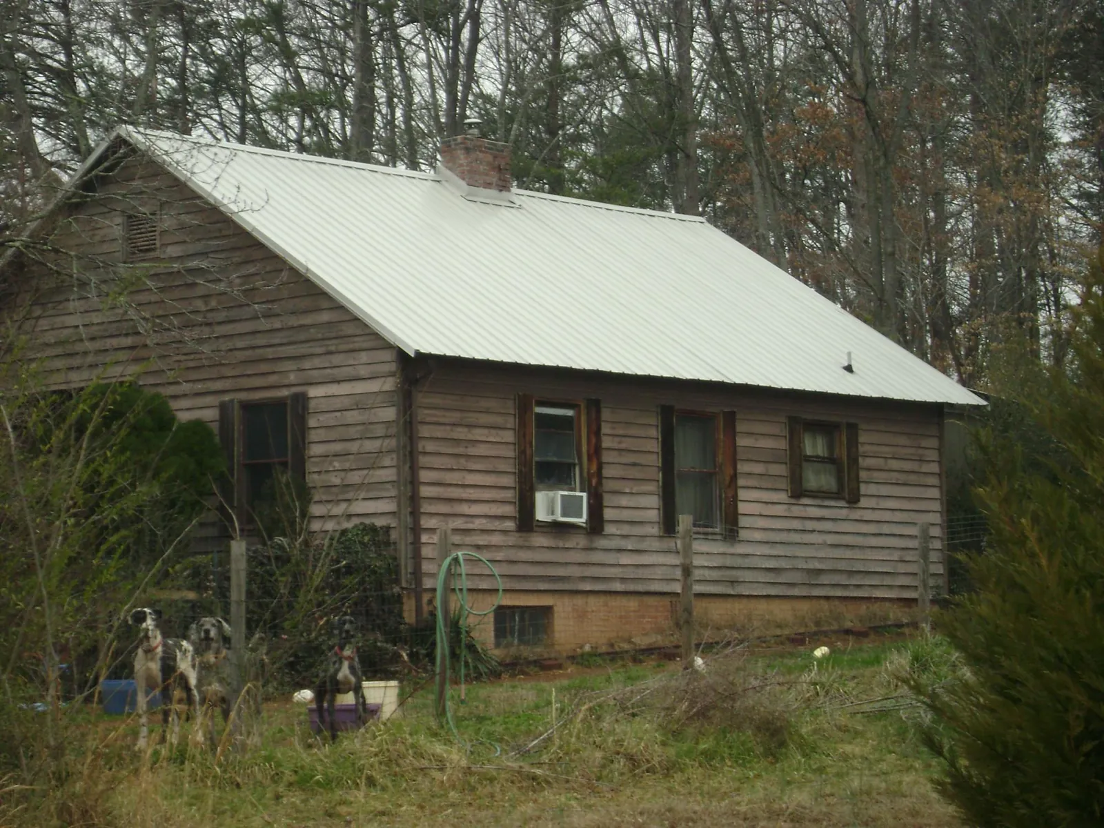 White metal roof on an old wood sided farmhouse, from a Metal Roof Installation job in Prescott